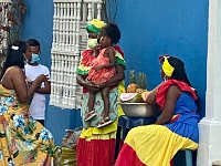 Native slave descendents in traditional dress offering fruit for sale. No people can live in historic district.
